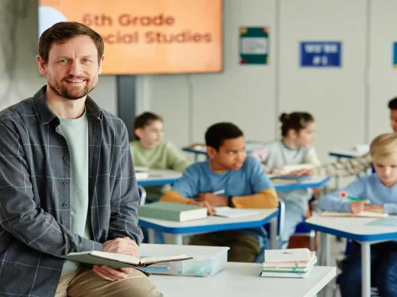 EBRC-male-teacher-sitting-on-desk-1440x800