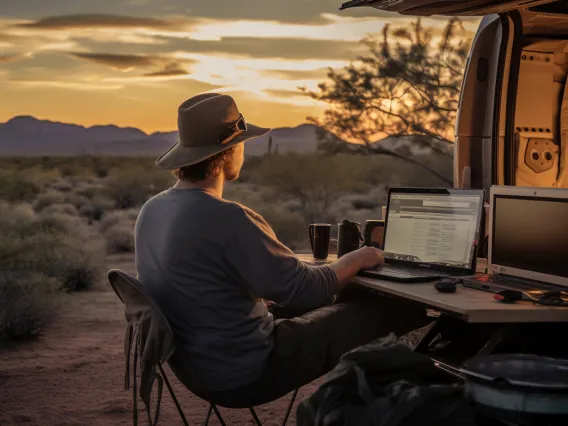 Man using computer in desert