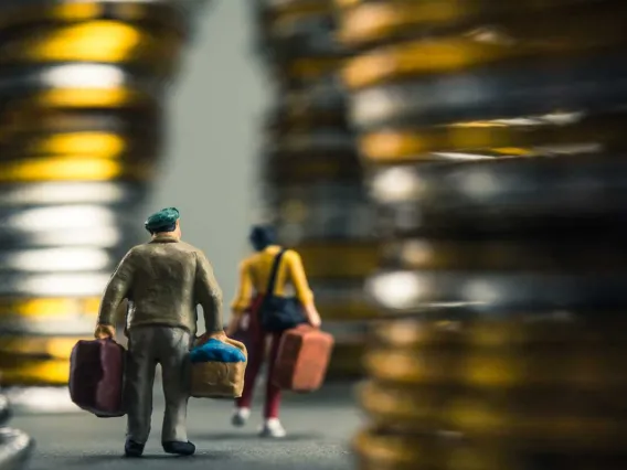 Couple walking luggage tall bronze hallways