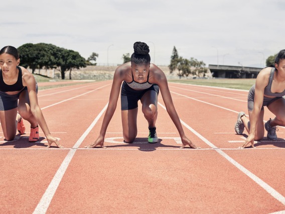 Three women track start line