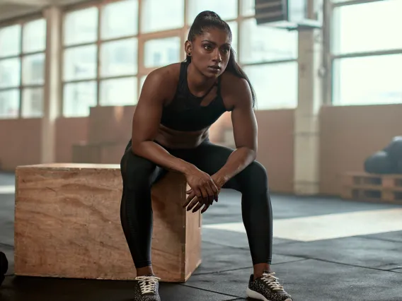 Woman sitting wood block in gym