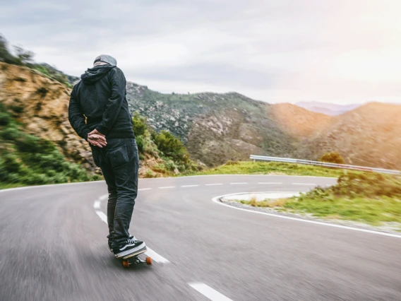 Man skating down road