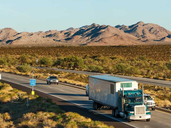 Cars and trucks on highway in desert