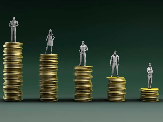 People standing on descending stacks of coins