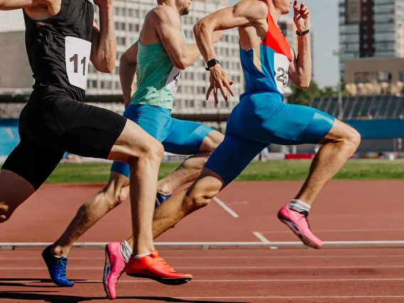 Three men racing on a track