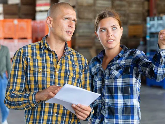 Warehouse workers collaborating